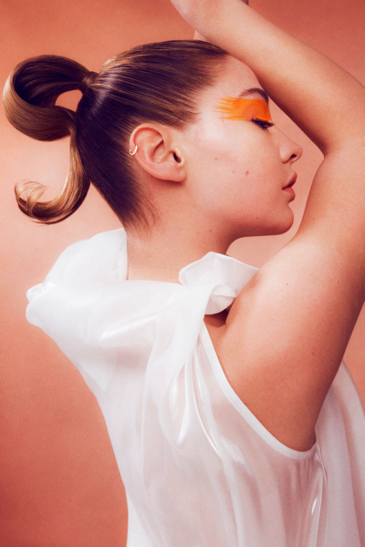 Madelyn Cline profile portrait with orange eye makeup