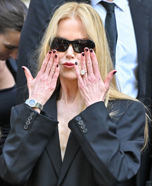 Nicole Kidman blows a kiss wearing a black blazer and sunglasses
