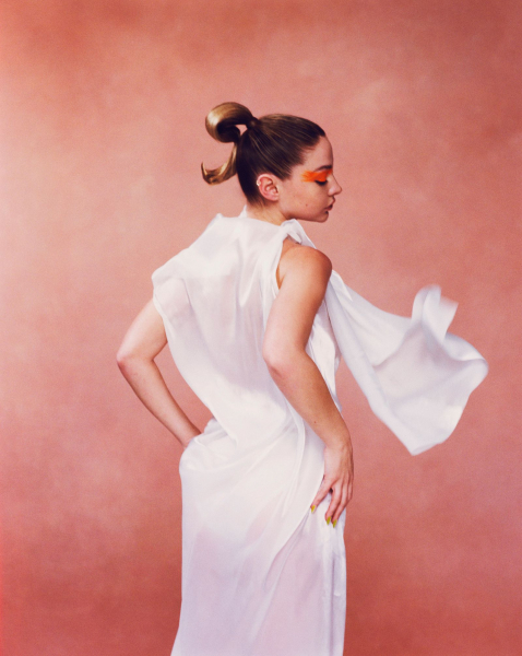 Madelyn Cline in white dress and orange eye makeup