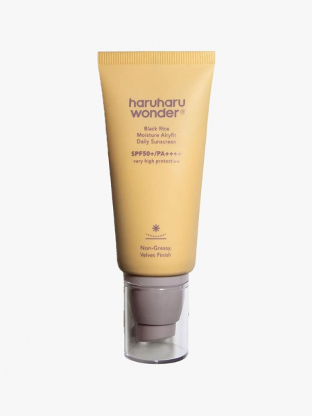 A yellow tuve of Haruharu Wonder Black Rice Moisture Airyfit Daily Sunscreen on a light gray background